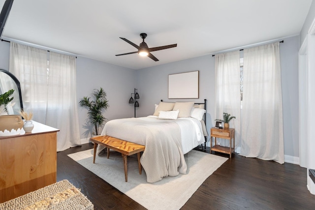 bedroom featuring dark wood-style floors, baseboards, and ceiling fan