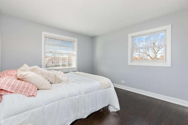 bedroom with dark wood-style floors and baseboards