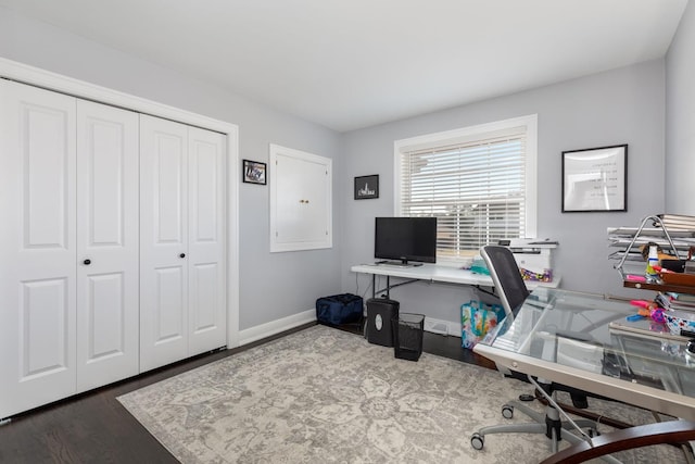 office space with baseboards and wood finished floors