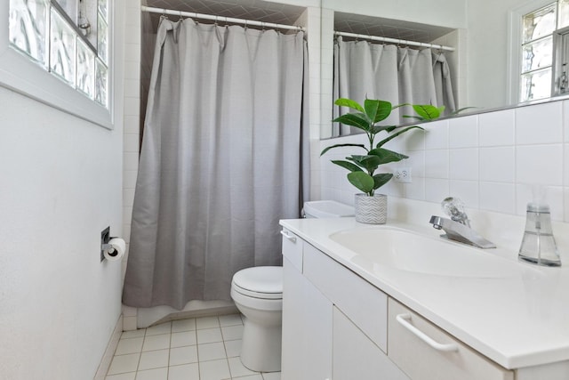 full bathroom featuring toilet, curtained shower, tile patterned flooring, decorative backsplash, and vanity