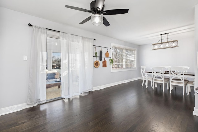 dining room with visible vents, baseboards, a ceiling fan, and wood finished floors