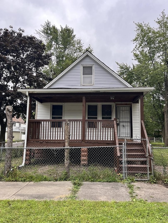 bungalow-style house featuring a porch and fence