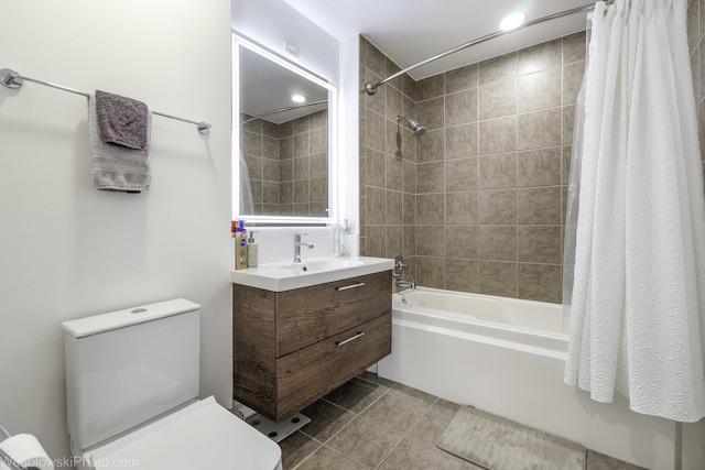 full bath featuring tile patterned floors, vanity, toilet, and shower / tub combo