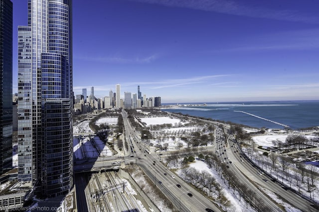 drone / aerial view featuring a city view and a water view