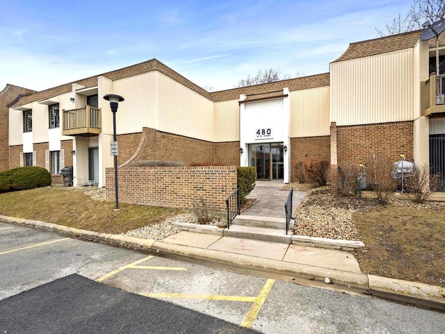 view of building exterior featuring uncovered parking