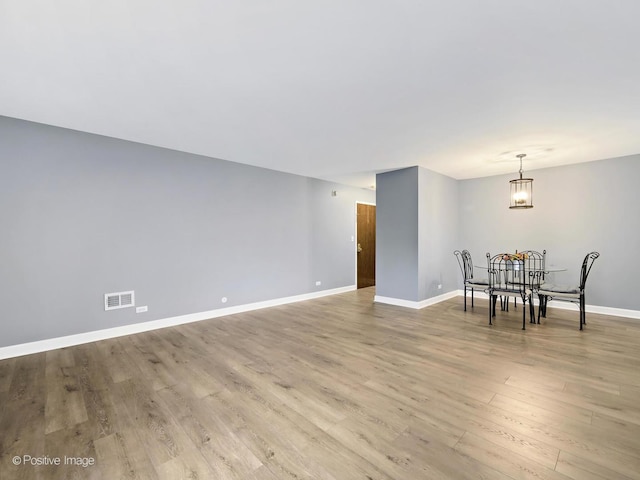 dining room with baseboards, visible vents, and light wood-type flooring