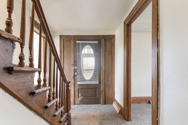 doorway to outside with stairs and carpet floors