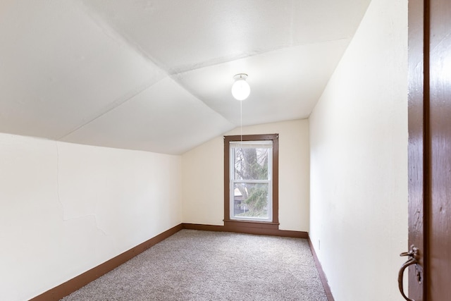 bonus room featuring carpet floors, baseboards, and vaulted ceiling