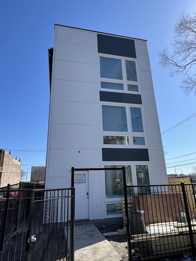 view of building exterior featuring fence