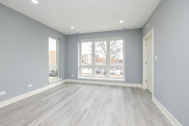 unfurnished room with visible vents, recessed lighting, baseboards, and light wood-style floors