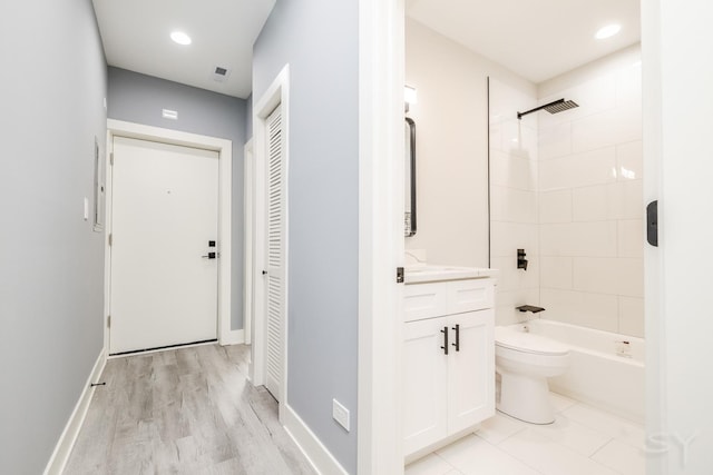 bathroom with baseboards, toilet, shower / bath combination, recessed lighting, and vanity