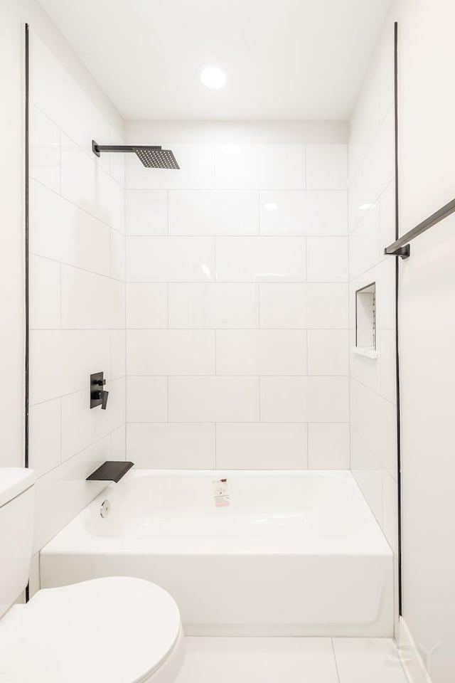 bathroom with tile patterned floors, toilet, and shower / bathtub combination