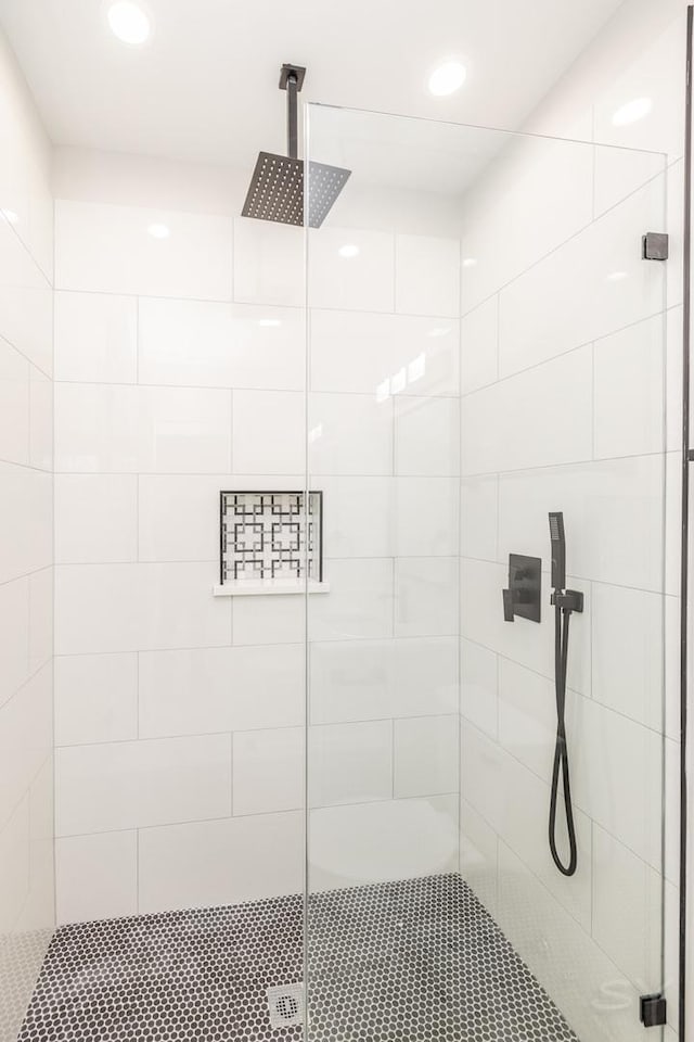 full bathroom featuring recessed lighting and a shower stall