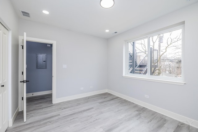 unfurnished bedroom featuring visible vents, recessed lighting, light wood-style floors, and baseboards