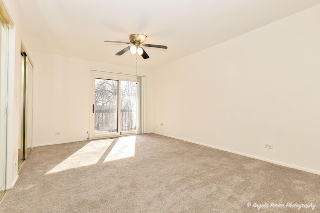 carpeted spare room with baseboards and ceiling fan