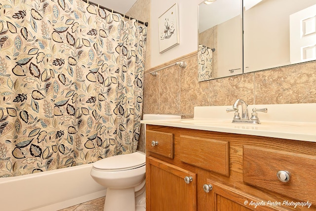 full bath with tile walls, toilet, shower / tub combo, tile patterned floors, and vanity