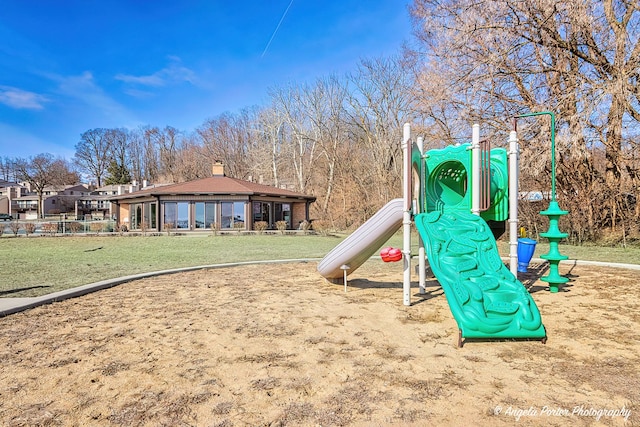 community jungle gym with a yard