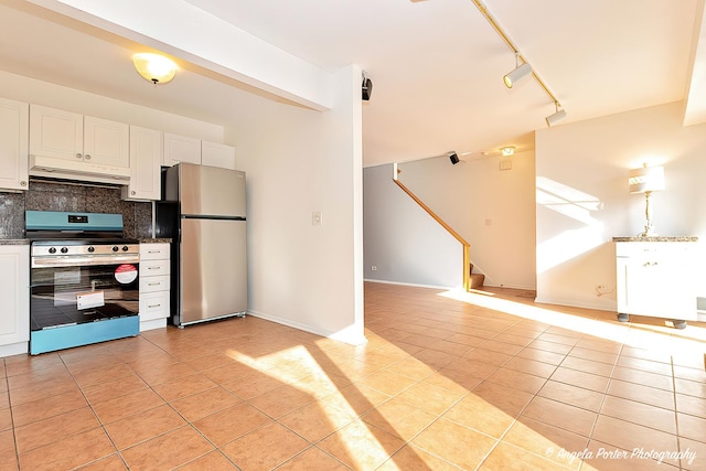 kitchen featuring backsplash, under cabinet range hood, light tile patterned floors, stainless steel appliances, and white cabinetry