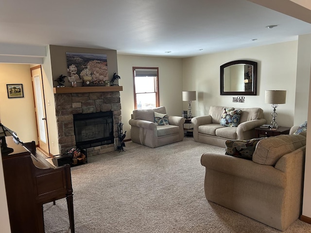 living area featuring a stone fireplace and carpet flooring