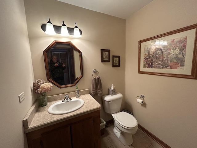 bathroom featuring vanity, tile patterned floors, toilet, and baseboards