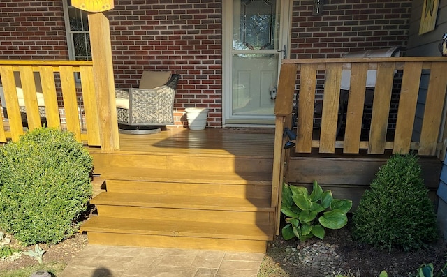 view of exterior entry with brick siding