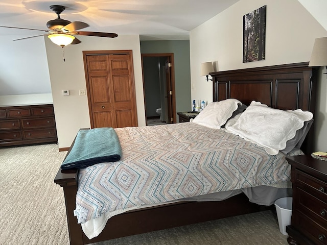 bedroom featuring a closet, ensuite bathroom, a ceiling fan, and carpet flooring