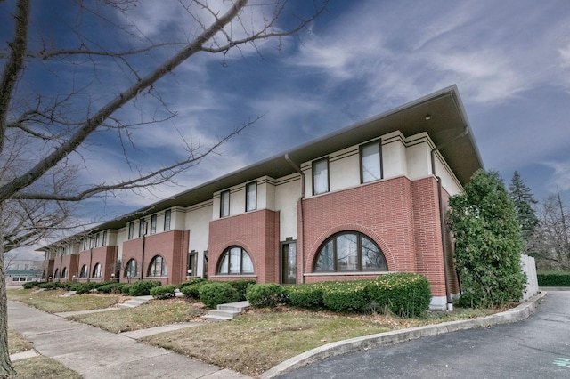 view of side of home with brick siding