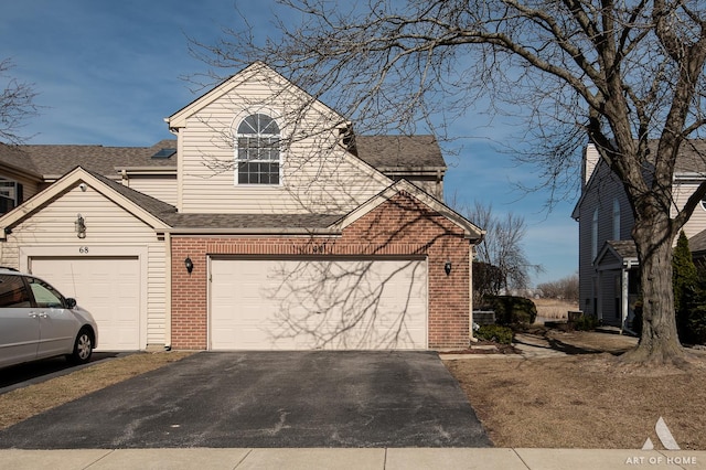 view of front of house with aphalt driveway, brick siding, and a shingled roof