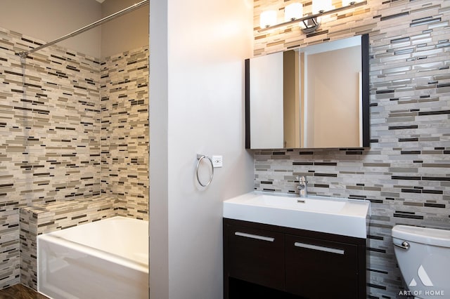 bathroom with toilet, a washtub, a shower, decorative backsplash, and vanity