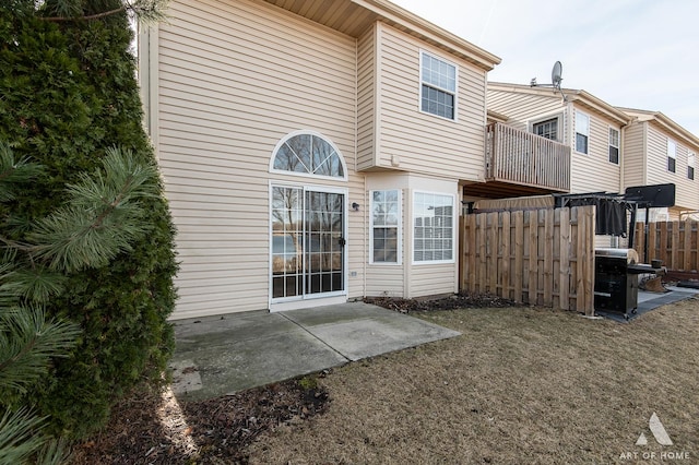 back of house featuring a patio and fence