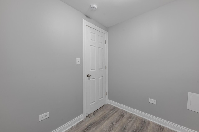 unfurnished room featuring baseboards and wood finished floors