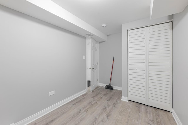 unfurnished bedroom featuring a closet, visible vents, light wood-type flooring, and baseboards