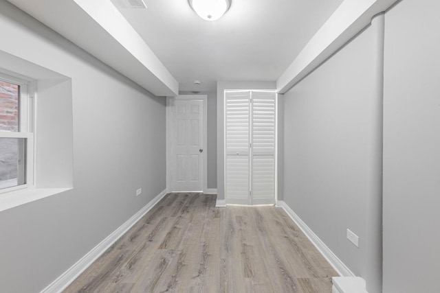 below grade area featuring baseboards and wood finished floors