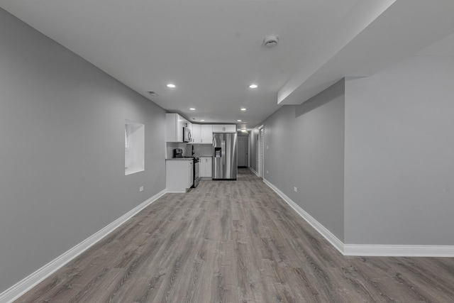 interior space featuring recessed lighting, visible vents, baseboards, and light wood finished floors