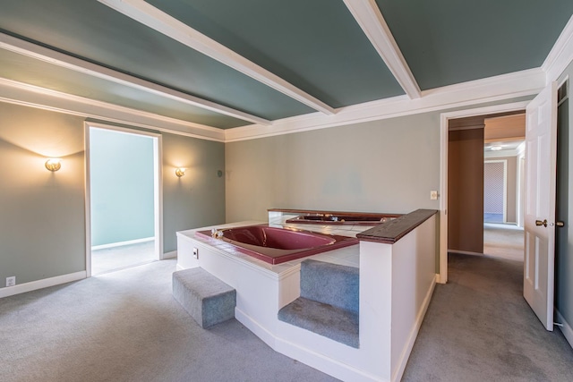 hallway with beam ceiling, crown molding, baseboards, and carpet floors