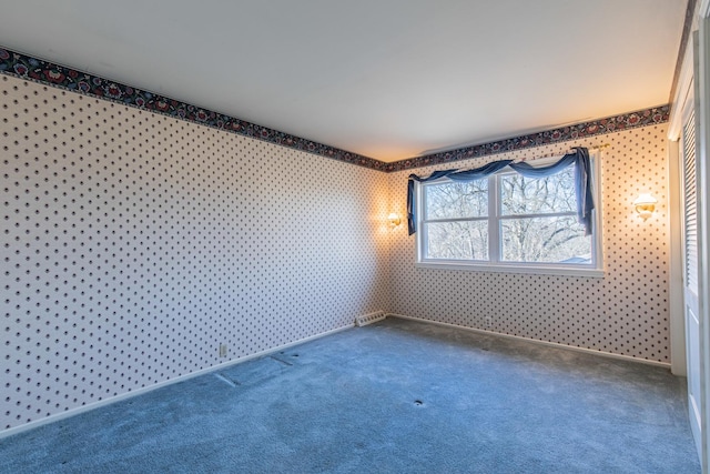 spare room featuring wallpapered walls, carpet flooring, and baseboards