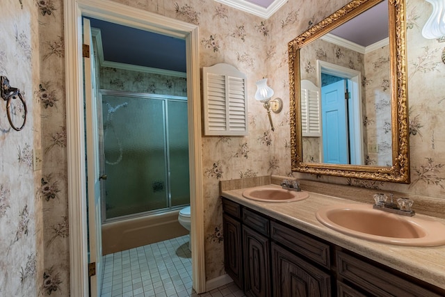 bathroom featuring wallpapered walls, toilet, tile patterned flooring, and a sink