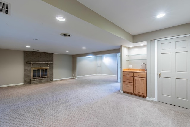 interior space with recessed lighting, visible vents, light carpet, and a brick fireplace