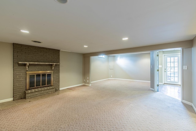 unfurnished living room with carpet flooring, recessed lighting, a fireplace, and baseboards