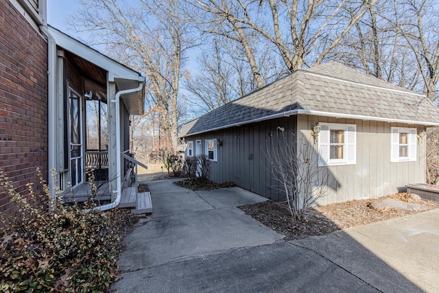 view of side of property featuring a shingled roof