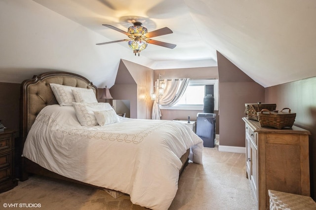 bedroom with light carpet, ceiling fan, baseboards, and vaulted ceiling