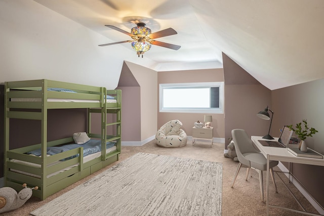 carpeted bedroom with lofted ceiling, baseboards, and ceiling fan