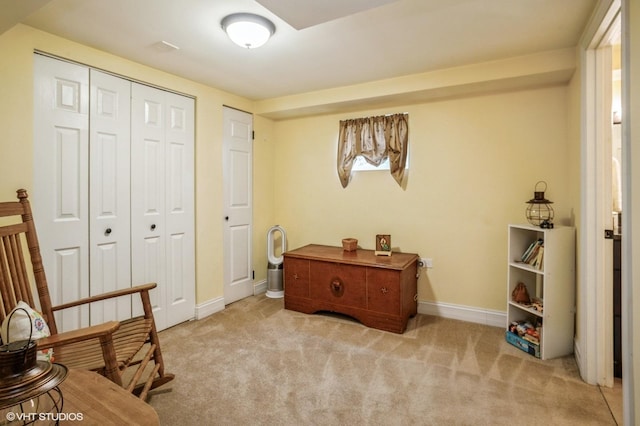 living area with baseboards and carpet flooring