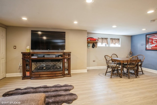 dining space with recessed lighting, baseboards, and wood finished floors