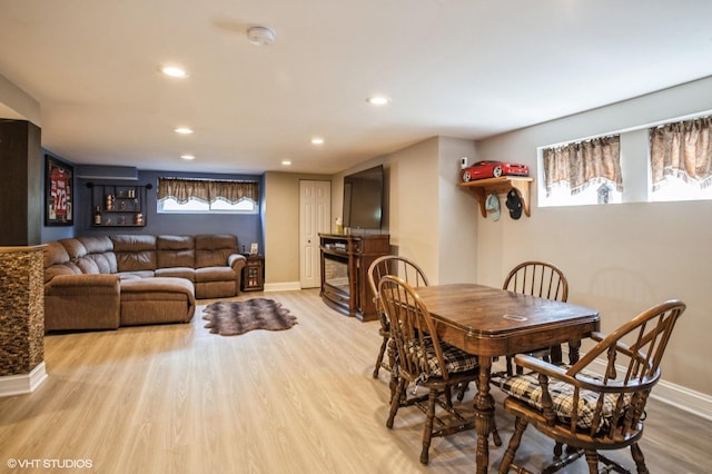 dining room featuring recessed lighting, baseboards, wood finished floors, and a fireplace