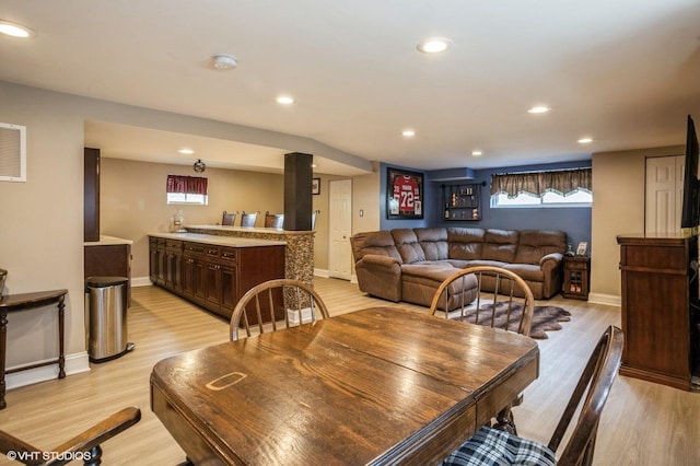 dining area with recessed lighting, light wood-style flooring, and baseboards