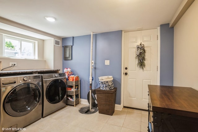 clothes washing area with visible vents, washer and dryer, light tile patterned floors, baseboards, and laundry area