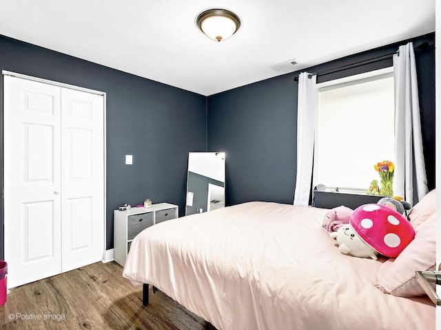 bedroom with visible vents and wood finished floors