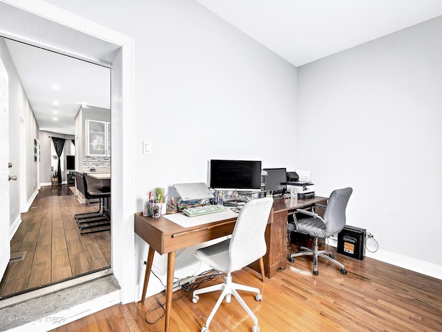 office with baseboards and wood finished floors