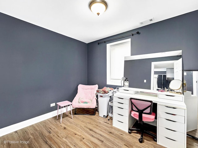 home office featuring visible vents, baseboards, and wood finished floors